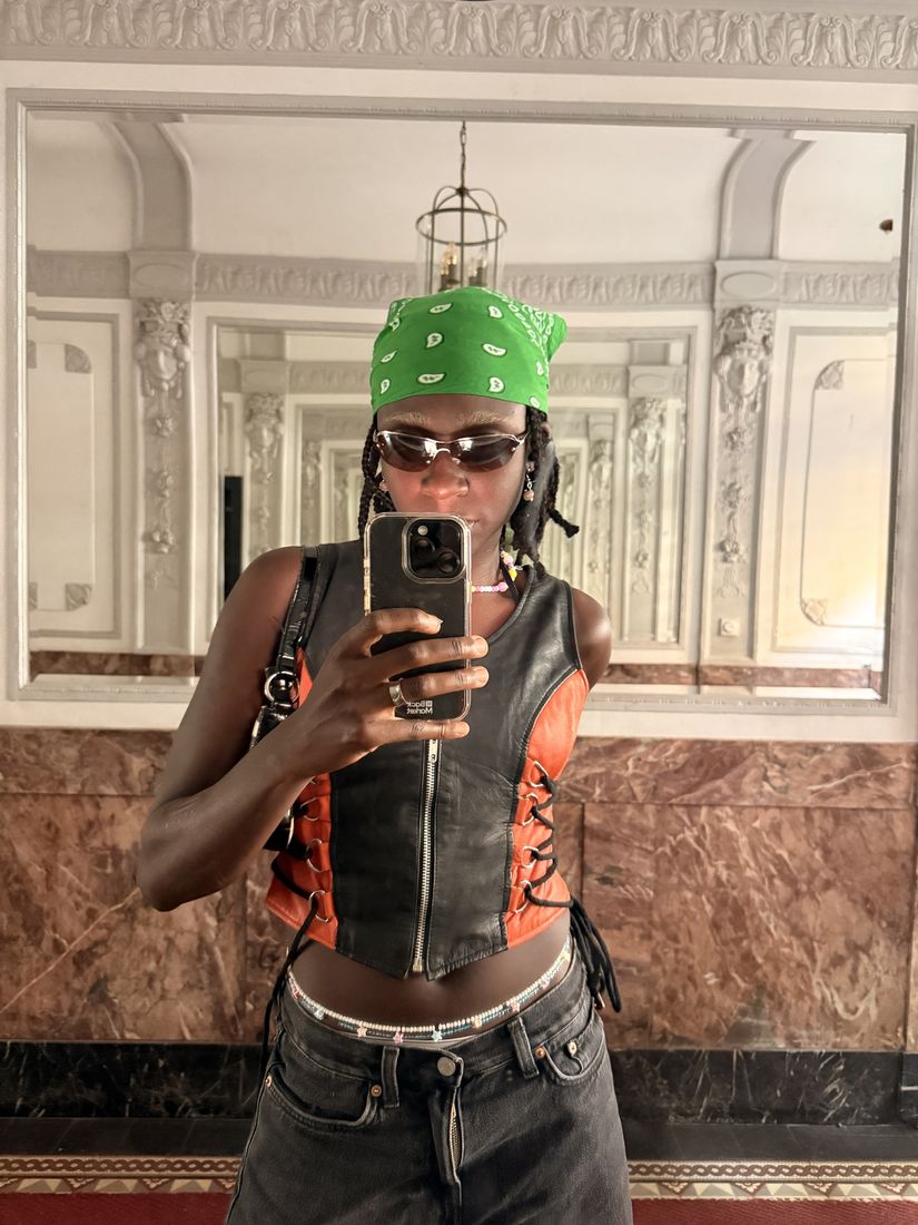 Member in a green bandana taking a mirror selfie