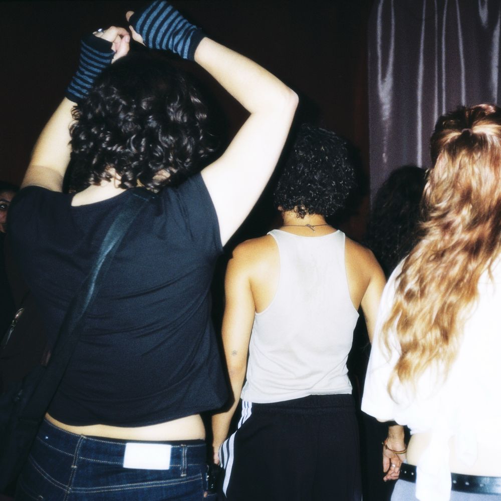 Friends dancing with their backs to the camera
